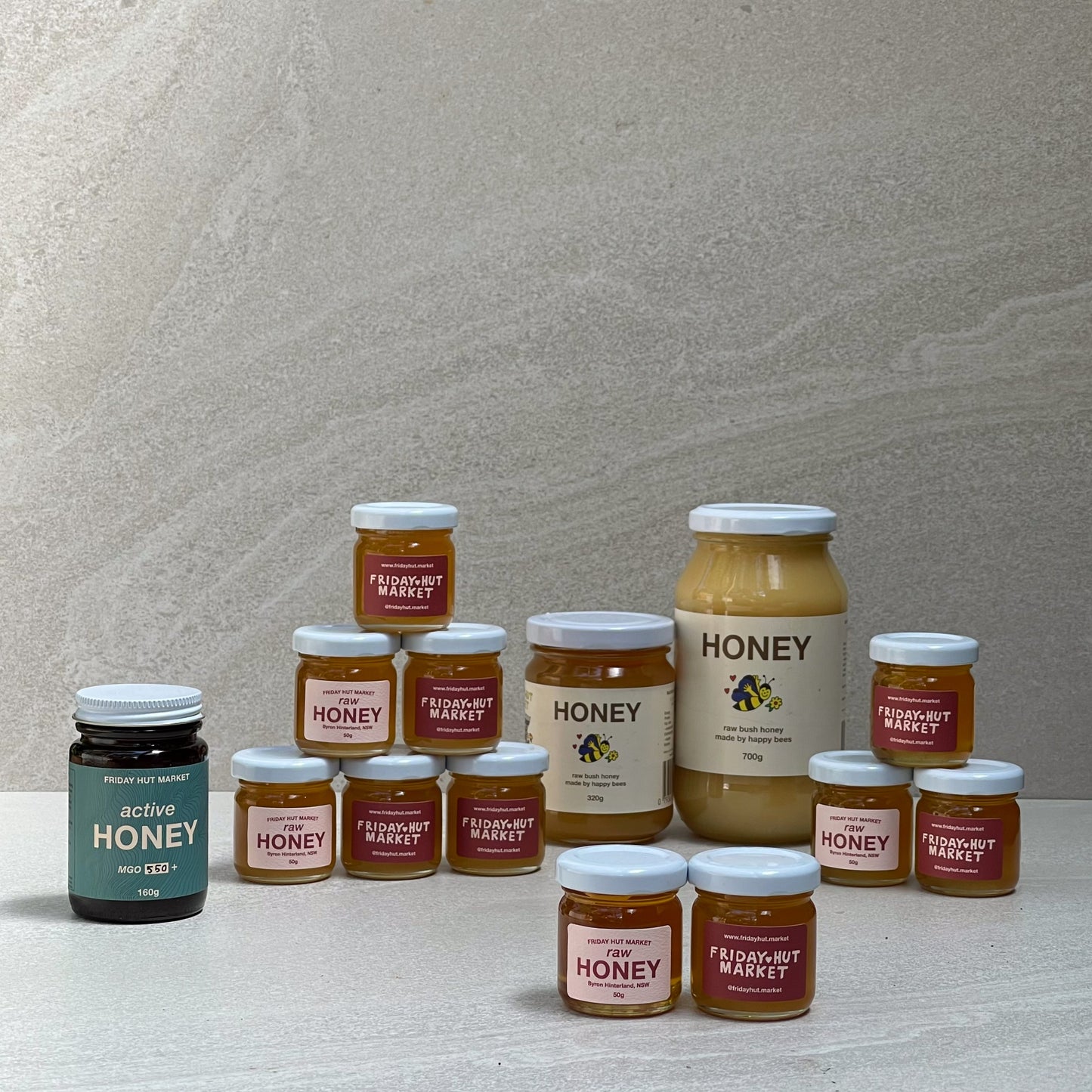 50g, 320g and 700g jars of Friday Hut Market Raw Bush Honey, and one jars of MG) 550+ Active Jellybush Manuka Honey.